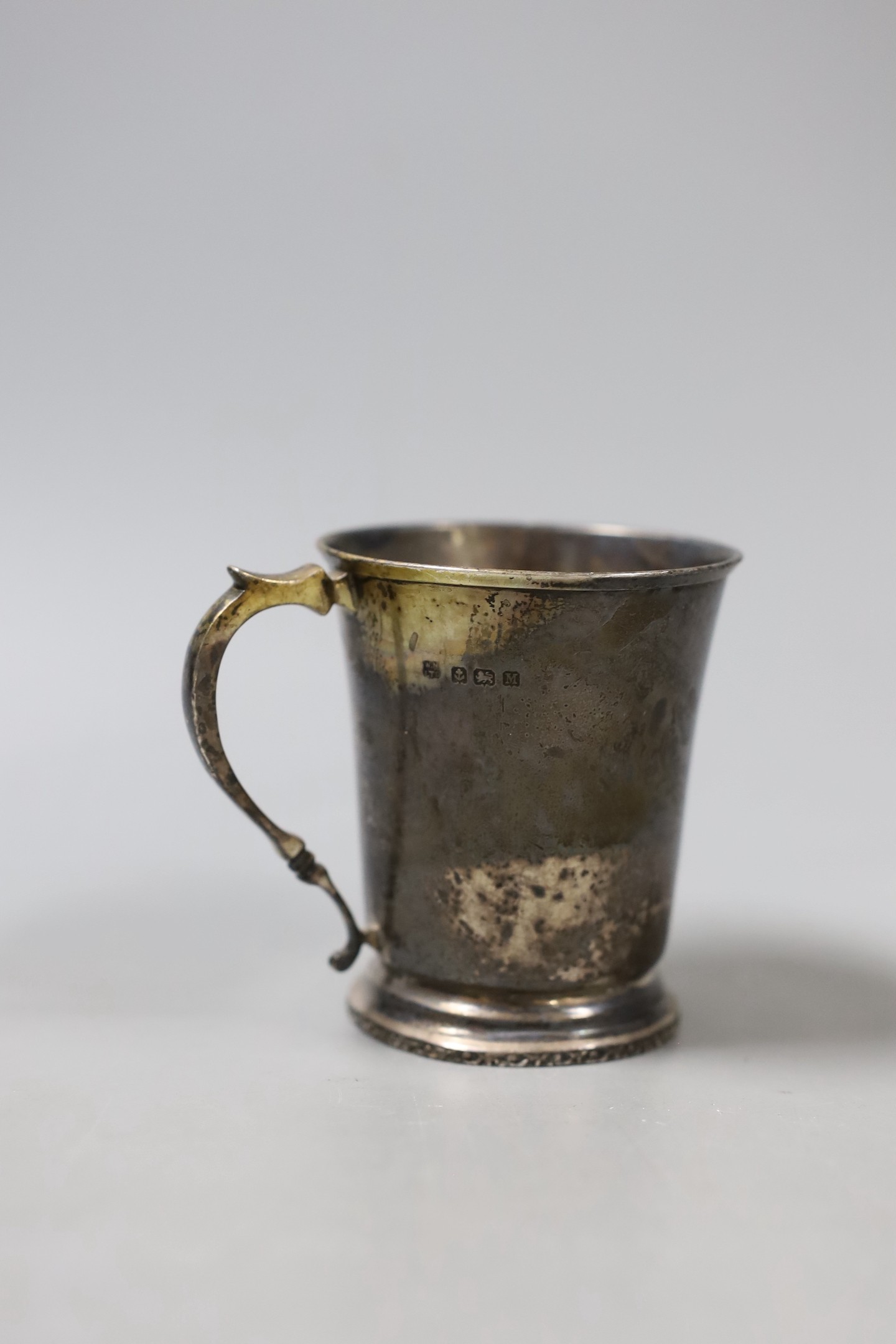 Two 18th century silver spoons, a later silver christening mug, small silver mounted heart shaped photograph frame, a silver napkin ring and a silver handled button hook.